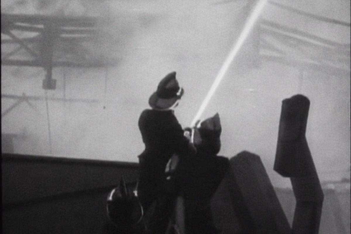 Firefighters directing a hose onto the blaze during the 1935 fire that tore through Twickenham Film Studios' main stage