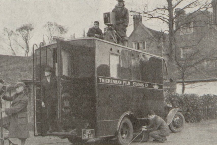 Twickenham Film Studios' mobile sound recording van on location, its name lettered along the side, with a camera operator filming from the roof