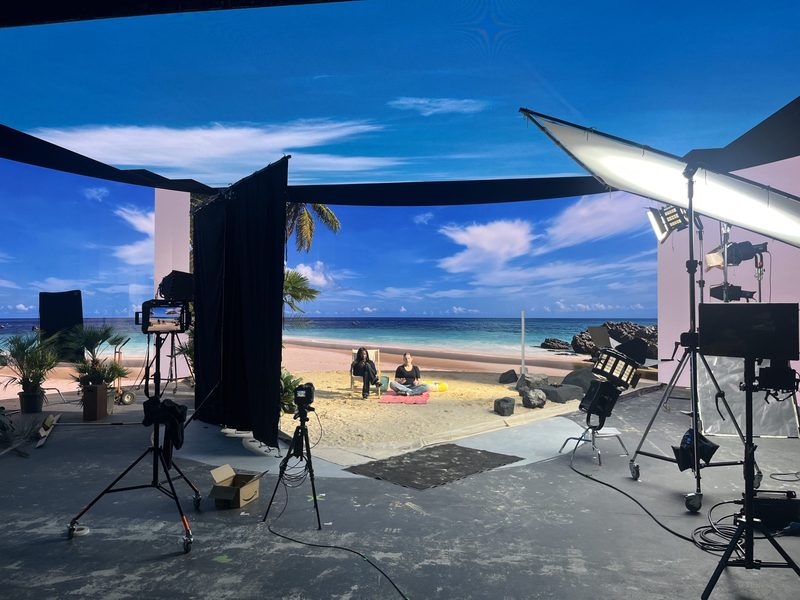 Filming on Stage 3's LED volume at Twickenham Film Studios, with a virtual beach environment displayed across the wraparound virtual production screen